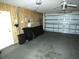 Spacious garage with a ceiling fan and plenty of room for parking and storage at 7632 Lake Forest Cir, Port Richey, FL 34668
