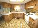 Cozy kitchen with wood cabinets, tile backsplash, and white appliances at 7632 Lake Forest Cir, Port Richey, FL 34668