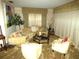 Cozy living room with plush seating, a coffee table, and natural light from large windows at 7632 Lake Forest Cir, Port Richey, FL 34668
