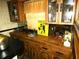 A quaint wet bar features wood cabinetry, countertop, and a sink near a window at 7632 Lake Forest Cir, Port Richey, FL 34668