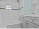 The bathroom features a tiled shower and tub with a vanity sink and storage at 800 Chesapeake Dr # 42, Tarpon Springs, FL 34689