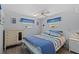 Cozy bedroom with a ceiling fan, windows, and a dresser. The room features blue accents at 800 Chesapeake Dr # 42, Tarpon Springs, FL 34689