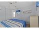 Comfortable bedroom with a ceiling fan, a small window, and an attached closet at 800 Chesapeake Dr # 42, Tarpon Springs, FL 34689