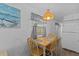 This dining area with a wooden table and chairs is near the kitchen at 800 Chesapeake Dr # 42, Tarpon Springs, FL 34689