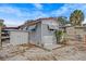 Exterior view of the home with a storage shed, car port, and gravel landscaping at 800 Chesapeake Dr # 42, Tarpon Springs, FL 34689