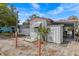 Exterior view of the home with storage shed, awning, and guest parking at 800 Chesapeake Dr # 42, Tarpon Springs, FL 34689