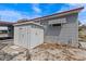 Exterior view of home with storage shed, gravel landscaping, and visible utilities at 800 Chesapeake Dr # 42, Tarpon Springs, FL 34689