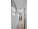 The hallway is narrow with wood-look floors and white walls with a glimpse to the bedroom at 800 Chesapeake Dr # 42, Tarpon Springs, FL 34689