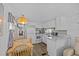Charming kitchen with white cabinets, modern appliances, an adjacent dining area, and hardwood floors at 800 Chesapeake Dr # 42, Tarpon Springs, FL 34689