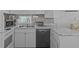 The kitchen features a dishwasher, tiled backsplash, marble-look countertops and a double sink at 800 Chesapeake Dr # 42, Tarpon Springs, FL 34689