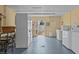 Well-lit laundry room with multiple washers and dryers and door to exterior at 800 Chesapeake Dr # 42, Tarpon Springs, FL 34689
