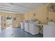 Bright laundry room featuring multiple white washing machines for community use at 800 Chesapeake Dr # 42, Tarpon Springs, FL 34689