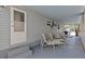 Covered patio with chairs, tables, and access to the main entrance at 800 Chesapeake Dr # 42, Tarpon Springs, FL 34689