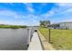 Beautiful view of the waterfront with a dock, clear sky, and lush greenery at 800 Chesapeake Dr # 42, Tarpon Springs, FL 34689