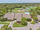 Aerial view of clubhouse, pool, golf course, and surrounding community at 8001 Summerbreeze Ter, Spring Hill, FL 34606