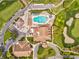 Aerial view of community amenities: pool, golf course, and parking for resident convenience at 8001 Summerbreeze Ter, Spring Hill, FL 34606