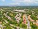 Aerial view of a house nestled in a community with lush greenery at 8001 Summerbreeze Ter, Spring Hill, FL 34606