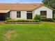 Well-manicured backyard featuring a lush lawn, greenery, and a screened in patio at 8001 Summerbreeze Ter, Spring Hill, FL 34606