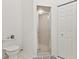 Clean bathroom featuring a glass shower, toilet, and ample storage at 8001 Summerbreeze Ter, Spring Hill, FL 34606