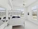 Bright bedroom with a white bunk bed, white ceiling fan and large windows at 8001 Summerbreeze Ter, Spring Hill, FL 34606