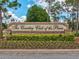 Elegant community sign amidst lush landscaping and clear blue skies at 8001 Summerbreeze Ter, Spring Hill, FL 34606