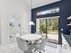 Dining area features a white table and chairs, complemented by a sliding glass door to an outdoor patio at 8001 Summerbreeze Ter, Spring Hill, FL 34606