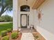 Welcoming front entrance featuring decorative door, overhead light and sunny decor at 8001 Summerbreeze Ter, Spring Hill, FL 34606