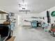 Clean garage with ample storage, blue grill and chairs, and convenient interior access at 8001 Summerbreeze Ter, Spring Hill, FL 34606