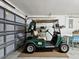 Spacious garage with a golf cart parked inside, featuring a clean and organized workspace at 8001 Summerbreeze Ter, Spring Hill, FL 34606