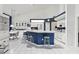 Bright, well-lit kitchen features white appliances and cabinetry contrasting with a navy blue breakfast bar at 8001 Summerbreeze Ter, Spring Hill, FL 34606