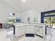 Bright and open kitchen with white cabinets and modern appliances at 8001 Summerbreeze Ter, Spring Hill, FL 34606