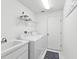 Functional laundry room featuring a sink, washer, dryer, and ample storage space at 8001 Summerbreeze Ter, Spring Hill, FL 34606