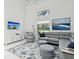 Modern living room features high ceilings, neutral tones, tile floors, and large windows allowing ample natural light at 8001 Summerbreeze Ter, Spring Hill, FL 34606