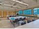 Bright meeting room featuring tile floors, long tables, and big windows overlooking greenery at 8001 Summerbreeze Ter, Spring Hill, FL 34606