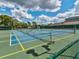 Outdoor community tennis court, showcasing well-maintained courts with shaded seating providing an active lifestyle at 8001 Summerbreeze Ter, Spring Hill, FL 34606