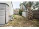 Private backyard features a shed, mature palm tree, and wood fence surrounding the perimeter at 803 Frances Dr, Tarpon Springs, FL 34689