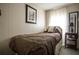 Cozy bedroom featuring a twin bed, side table, and a sailboat picture on the wall at 803 Frances Dr, Tarpon Springs, FL 34689