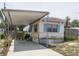 Charming single-story home with carport and landscaped front yard provides a welcoming curb appeal at 803 Frances Dr, Tarpon Springs, FL 34689