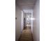 Hallway with wood flooring leading to multiple rooms with bright lighting at 803 Frances Dr, Tarpon Springs, FL 34689