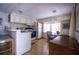 Bright eat-in kitchen features modern appliances, ample cabinet space, and wood laminate flooring at 803 Frances Dr, Tarpon Springs, FL 34689