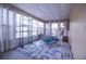 Sunroom with tiled floors, lots of natural light, and seating area with a glass table at 803 Frances Dr, Tarpon Springs, FL 34689