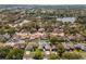 Aerial shot showcasing a residential neighborhood with mature trees and homes, some featuring private pools at 8749 Aruba Ln, Port Richey, FL 34668