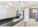 Bathroom featuring a dark granite countertop vanity with a tiled shower and tile floors at 8749 Aruba Ln, Port Richey, FL 34668