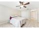 Neutral bedroom featuring a comfortable bed, closet, and tile floors at 8749 Aruba Ln, Port Richey, FL 34668
