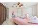 Bedroom featuring tile floors, a ceiling fan, and ample storage at 8749 Aruba Ln, Port Richey, FL 34668