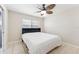 This bedroom offers a ceiling fan and tile floors at 8749 Aruba Ln, Port Richey, FL 34668