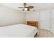 The bedroom has a ceiling fan and tile floors at 8749 Aruba Ln, Port Richey, FL 34668