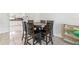 The formal dining area has a round table with a six-chair set and tile flooring at 8749 Aruba Ln, Port Richey, FL 34668