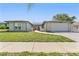 Charming single-story home features a well-maintained lawn and attached two-car garage at 8749 Aruba Ln, Port Richey, FL 34668