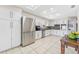Spacious kitchen with white cabinets, stainless appliances, and large tile flooring at 8749 Aruba Ln, Port Richey, FL 34668
